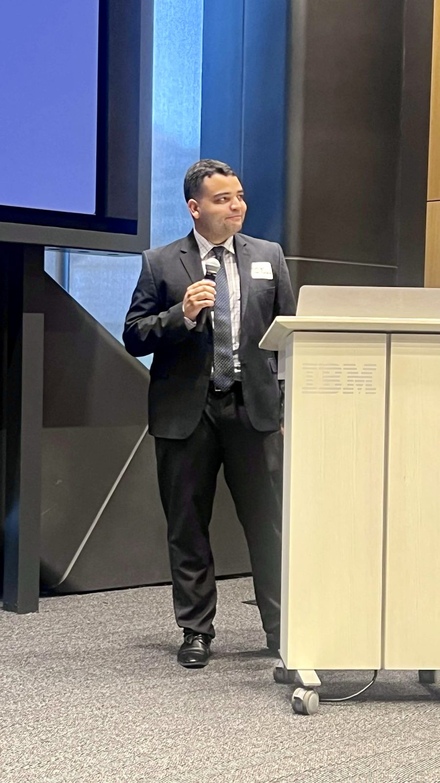 Rodrigo presenting with a microphone at UN Open Source Week Community Day