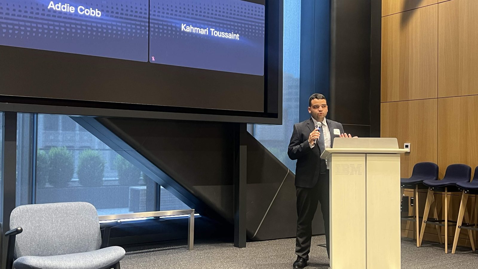 Rodrigo speaking at a podium at UN Open Source Week Community Day